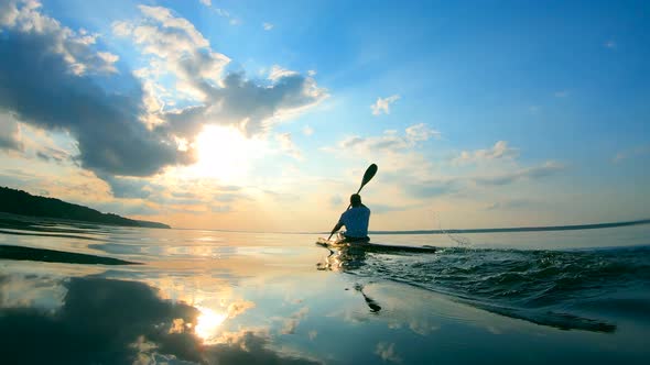 Backside View of a Male Paddler While Rowing