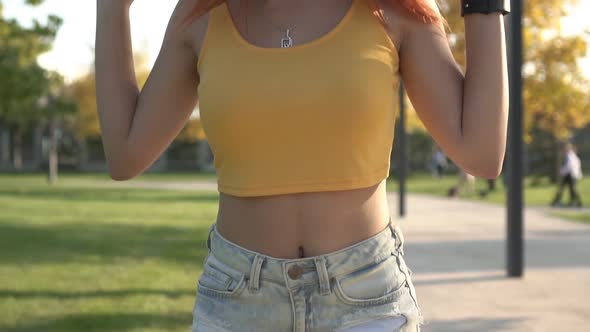 Athletic Sexy Woman Walks in the Park on a Sunny Day