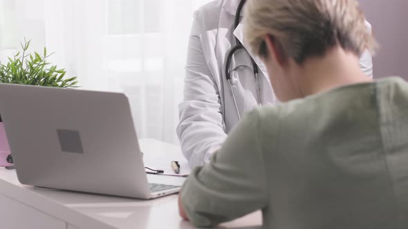 Woman Patient Sitting in Doctor's Office Clinic Receiving Bad Analysis Results