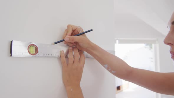 Portrait of a Caucasian woman in quarantine during coronavirus pandemic, doing interior work