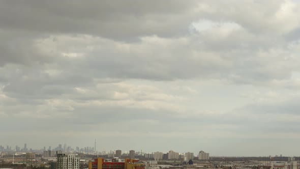 Timelapse of cloudy sky with minimalistic cityscape in Toronto, Canada