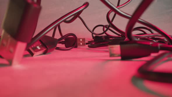 Knotty USB Wires at Red Illumination of Studio Room Macro