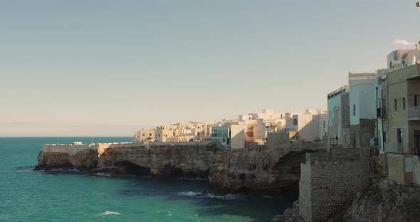 old European city on stone cape near sea, the waves hit the edge of the houses