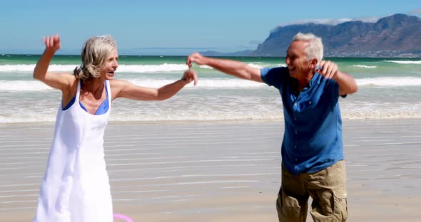 Senior couple enjoying together at the beach