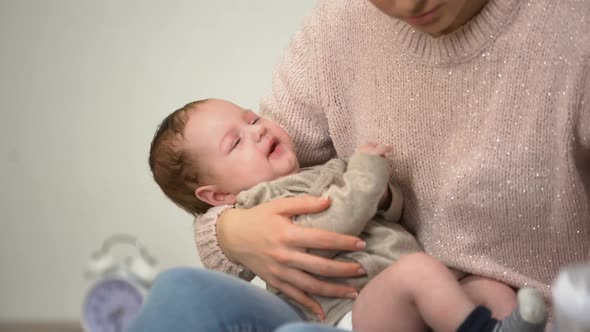 Young Mom Feeding Little Baby Son From Bottle, Infant Formula Artificial Feeding