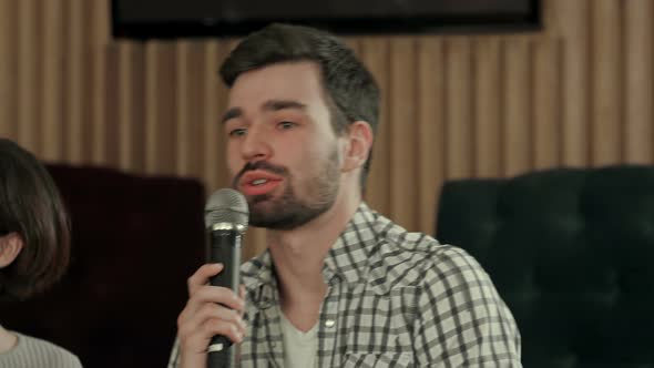 Young Man Is Singing a Song in Club