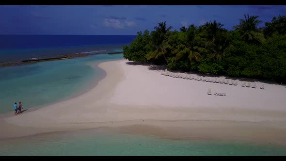 Aerial nature of perfect tourist beach holiday by blue sea with white sand background of a dayout ne