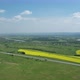 Aerial View of Asphalted Intercity Speed Highway Passing Through Green and Yellow Rural Fields River - VideoHive Item for Sale