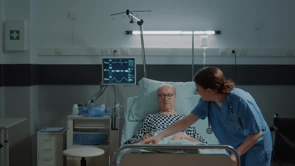 Nurse From Hospital Ward Taking Care of Sick Patient