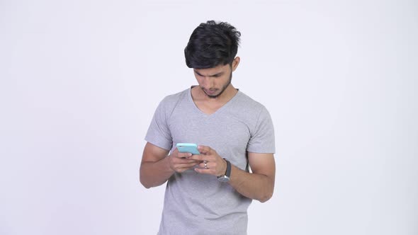 Young Happy Bearded Indian Man Using Phone