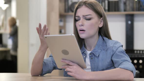 Tense Girl Reacting to Financial Loss While Using Tablet