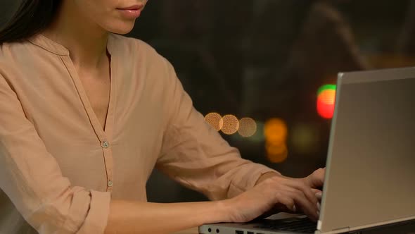 Young Female Employee Working on Laptop, Preparing Financial Analytics Report