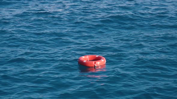 Life Buoy or Rescue Buoy Floating on Sea To Rescue People From Drowning Man. Slow Motion