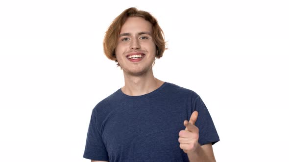 Portrait of Attractive Man in Casual Tshirt Grinning and Showing Thumb Up on Camera with Happy Smile