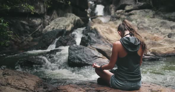 Thailand's Waterfall Woman Meditation Pose on River Bank