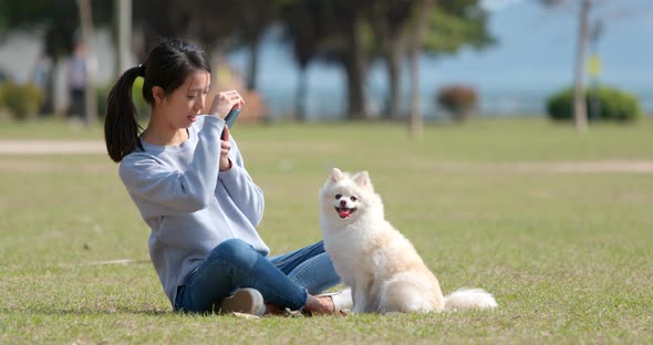 Woman playing with her dog at outdoor park