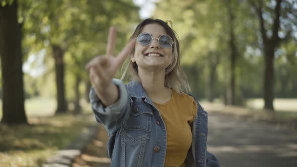 Positive Young Beautiful Hippie Woman Sunglasses Smiling Camera Showing Peace Gesture