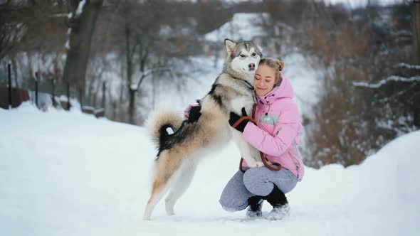 A Young Girl Petting Her Dog