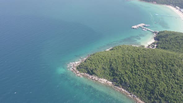 Aerial view of Koh Larn beach, Pattaya with blue turquoise seawater, mountain hills