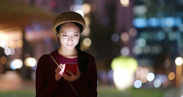 Young woman use of mobile phone in the street