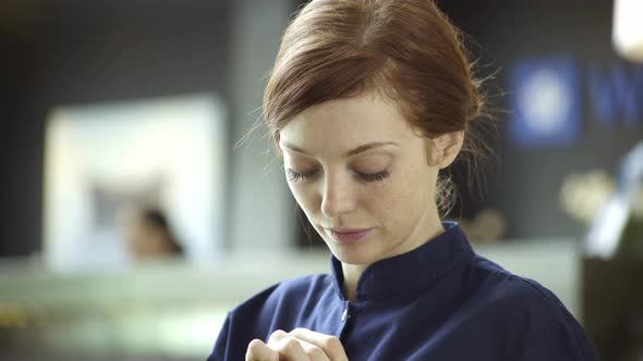 Woman looking down shyly and then smiling at camera