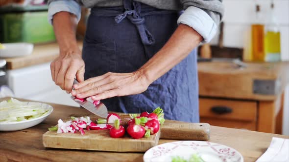 Woman cutting radishes