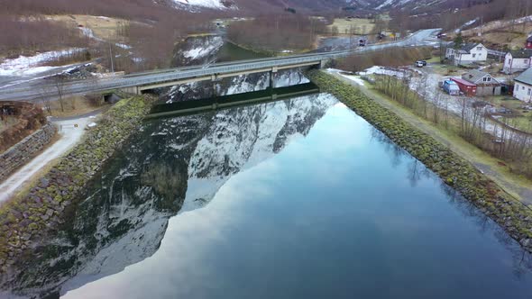 Bridge with road E16 crossing Gudvangen river Norway - Forwarding aerial above naeroy valley river w