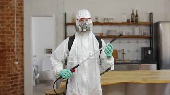 Portrait of Specialist in Hazmat Suit Doing Apartment Disinfection