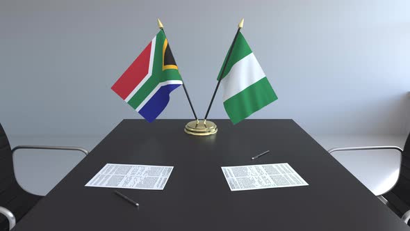 Flags of South Africa and Nigeria on the Table