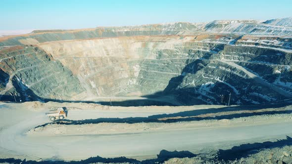 Massive Openpit Mine with a Truck Riding Around It