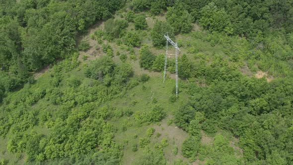 Electric power pylon and transmission cables from above 4K aerial video