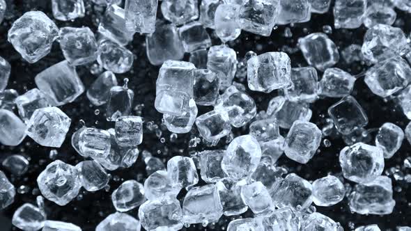 Super Slow Motion Shot of Ice Cubes Explosion Towards Camera Isolated on Black at 1000 Fps alt