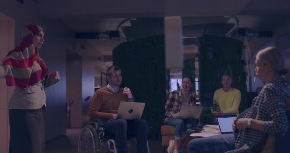 Businesswoman in Wheelchair Having Business Meeting with Team at Modern Office