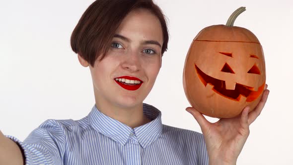 Lovely Red Lipped Woman Taking Selfies with Carved Halloween Pumpkin