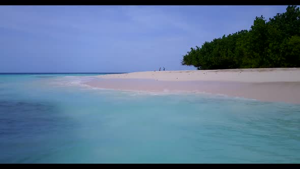 Aerial panorama of tranquil island beach journey by blue lagoon with white sandy background of a day