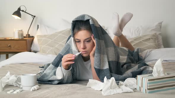 Sick Woman Measuring Temperature Her Body on the Bed