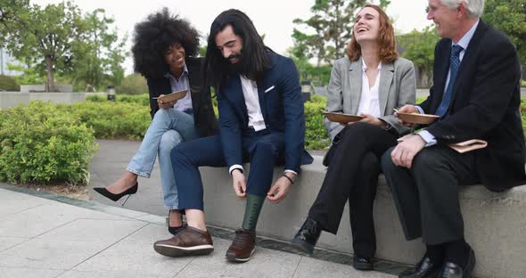 Multiethnic business people doing lunch break outdoor from office building