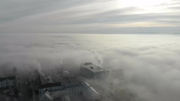 Aerial View at the Houses That Are Covered with Morning Fog. Flight Over the City of Lviv in Ukraine
