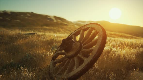 Old Wooden Wheel on the Hill at Sunset alt