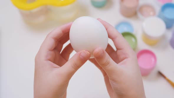 Little Toddler Girl Holding Egg in Her Hands