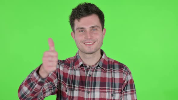 Portrait of Young Man Showing Thumbs Up Sign Green Chroma Screen