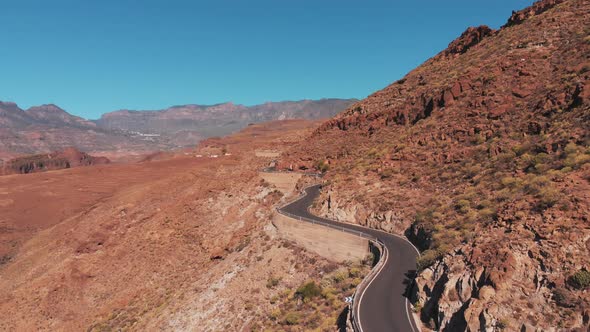 Aerial view of road between rocky mountains in Canary Island