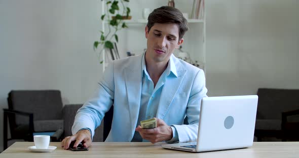 Successful Business Man Investor Sits at Table in Office Uses Mobile Phone Device for Communication