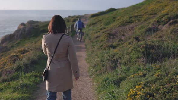 A Girl with a Short Hairstyle Walks Along the Path