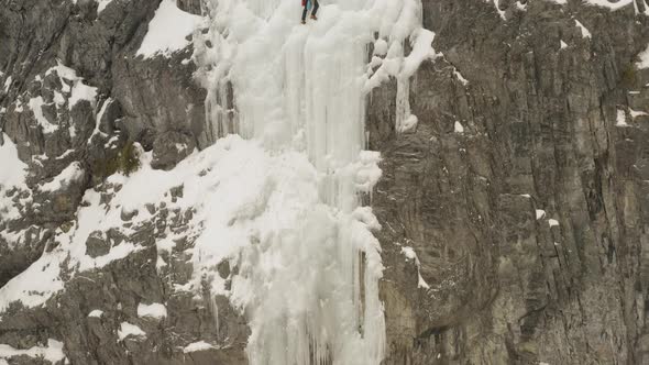 Astonishing aerial reveals two extreme climbers scaling frozen cliff face 4K