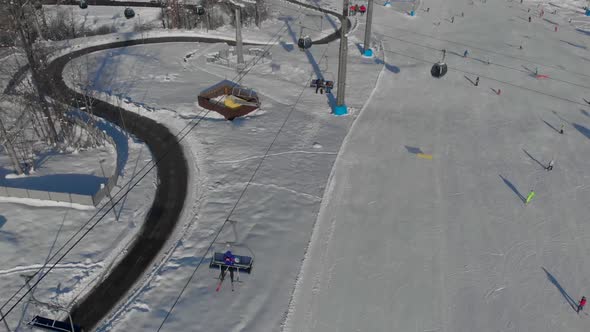 Aerial Photography of a Ski Resort with a Drone From a Height Ski Lifts and People Skiing Skating on