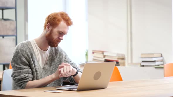 Man Using Smartwatch at Work in Office