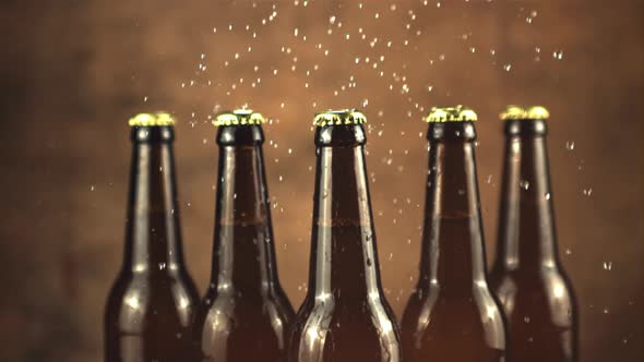 Super Slow Motion on Glass Beer Bottles Drops Water