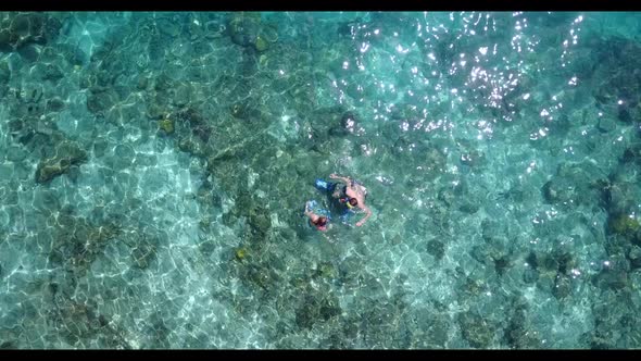 Young couple relax on paradise bay beach time by blue water with white sand background of the Maldiv