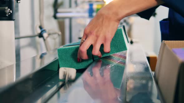 Sponges Are Getting Put Onto the Conveyor Belt. Packing Process at Industrial Factory.